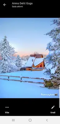 a television screen with a picture of a house covered in snow at Ponijeri in Kakanj