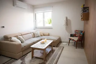 a living room with a couch and a table at Lilium in Cazin