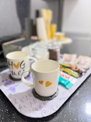 two coffee cups sitting on a tray on a counter at Lilium in Cazin