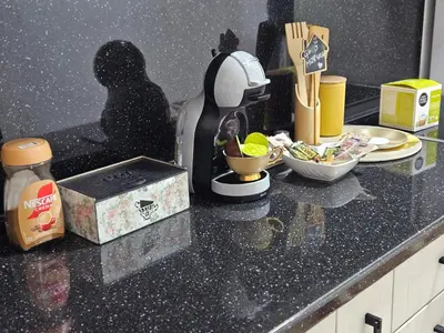 a kitchen counter with a mixer and a box on it at Lilium in Cazin