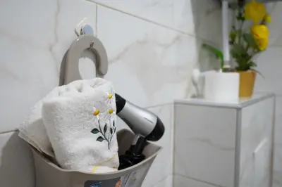 a towel holder with a blow dryer in a bathroom at Lilium in Cazin