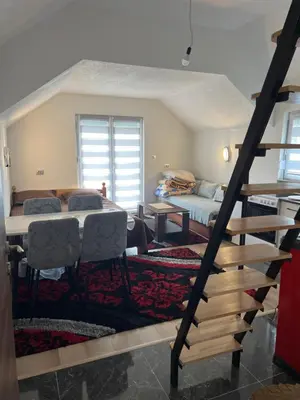 a bedroom with a bed and a table and chairs at Vikendica Brljak in Gostilj