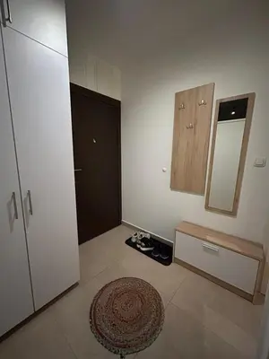 a room with a door and a mirror on the wall at Apartman Greenville Banja Luka in Banja Luka