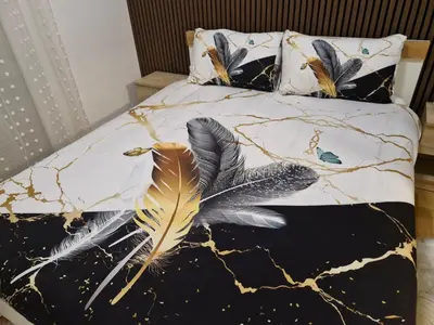 a bedroom with a bed with feathers on it at Apartman Greenville Banja Luka in Banja Luka