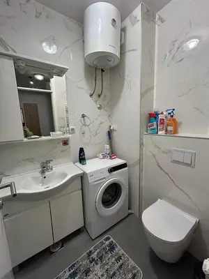 a bathroom with a washing machine and a sink at Apartman Greenville Banja Luka in Banja Luka