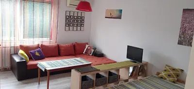a living room with a couch and a table at Jukan Apartman in Tuzla