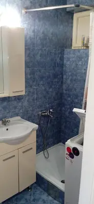 a bathroom with a shower and a sink and a tub at Jukan Apartman in Tuzla