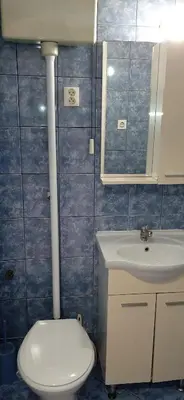 a bathroom with a toilet and a sink at Jukan Apartman in Tuzla