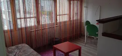 a living room with a couch and some windows at Jukan Apartman in Tuzla