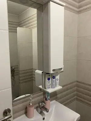a bathroom with a sink and a mirror at Apartman Sanja in Doboj