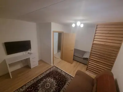 a living room with a couch and a television at Apartman Veni in Zenica