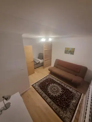 a living room with a couch and a rug at Apartman Veni in Zenica