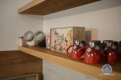 a shelf with tea pots and a box on it at Lux Apartment 1 - Zenica in Zenica
