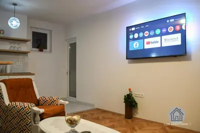 a living room with a flat screen tv on the wall at Lux Apartment 1 - Zenica in Zenica