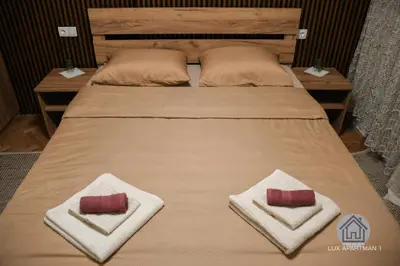 a bed with two pillows on top of it at Lux Apartment 1 - Zenica in Zenica