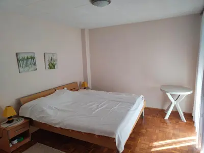 a bedroom with a bed and a table in it at Stella in Banja Luka
