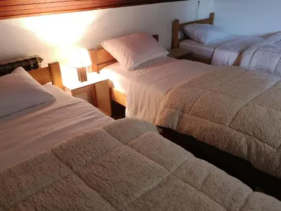 a hotel room with two beds and a lamp at Evergreen in Banja Luka
