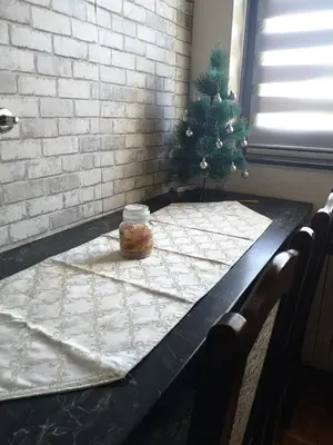 a table with a christmas tree on top of it at Evergreen in Banja Luka