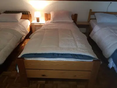 a bedroom with two beds and a lamp on a table at Evergreen in Banja Luka