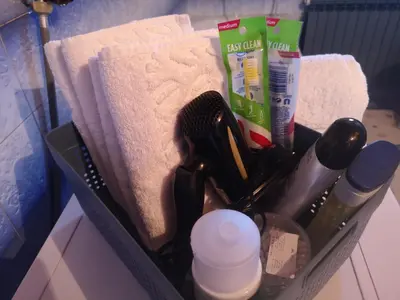 a basket filled with bathroom items and towels at Evergreen in Banja Luka