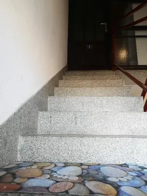 a set of stairs with a door and a mosaic floor at Evergreen in Banja Luka