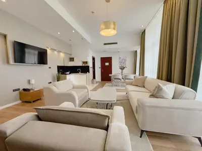 a living room with white couches and a table at Hotel Via Vitez in Vitez