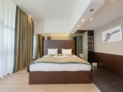 a bedroom with a large bed in a room at Hotel Via Vitez in Vitez