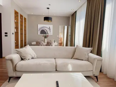 a living room with a white couch and a table at Hotel Via Vitez in Vitez