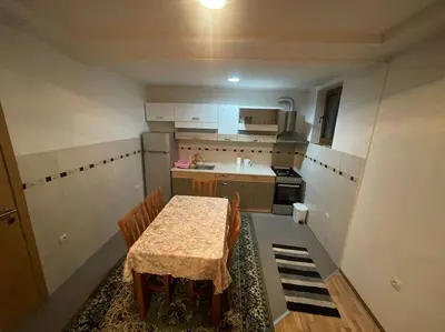 a small kitchen with a table and chairs in it at Apartment Vlasic in Šišava