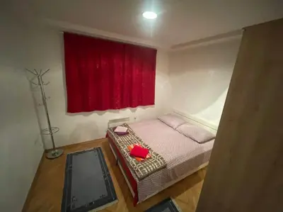 a bedroom with a bed with a red window at Apartment Vlasic in Šišava
