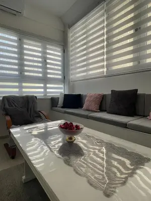 a living room with a bowl of fruit on a coffee table at Apartman Mole in Livno