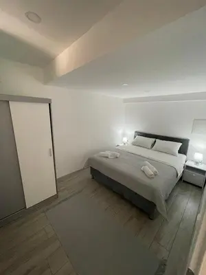 a bedroom with a bed with two towels on it at Apartman Mole in Livno