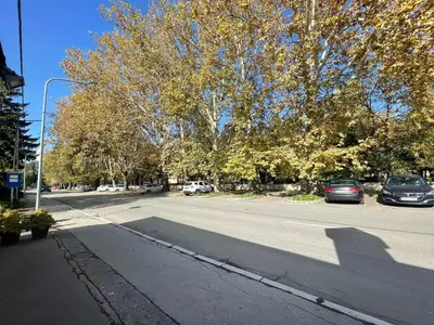 a street with cars parked on the side of the road at Apartman Mole in Livno