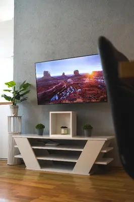 a living room with a flat screen tv on a wall at Apartman Gnječ Kupres in Kupres