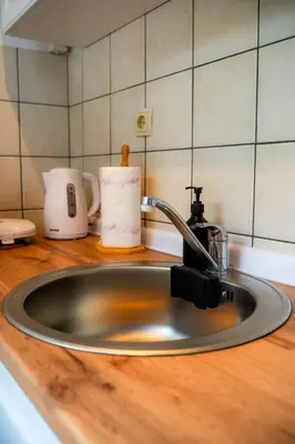 a kitchen sink with a faucet on a counter at Apartman Gnječ Kupres in Kupres