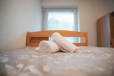 a towel animal laying on top of a bed at Apartman Gnječ Kupres in Kupres