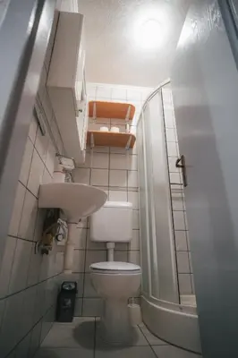 a small bathroom with a toilet and a sink at Apartman Gnječ Kupres in Kupres
