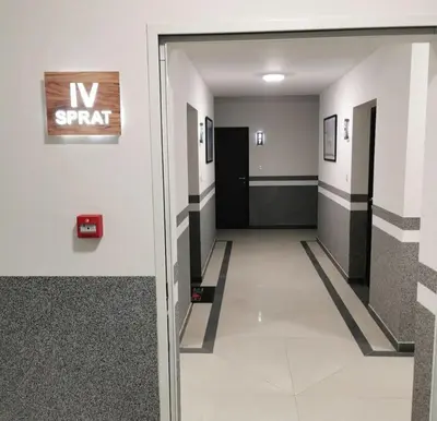 a hallway with a exit sign in a building at Alex LUX Banjaluka in Železnička Stanica Incel