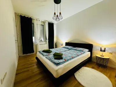 a bedroom with a large bed in a room at Apartman-Amko in Tuzla