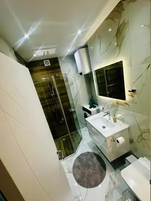 a bathroom with a shower and a sink at Apartman-Amko in Tuzla