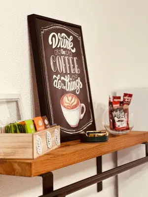a sign on a shelf with a coffee shop sign at Apartman-Amko in Tuzla