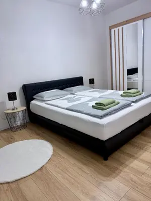 a bedroom with a large bed in a room at Apartman-Amko in Tuzla