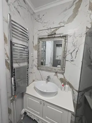 a bathroom with a sink and a mirror at Apartman SANDRA in Modriča