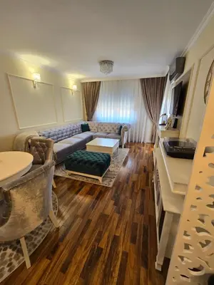 a living room with a couch and a table at Apartman SANDRA in Modriča