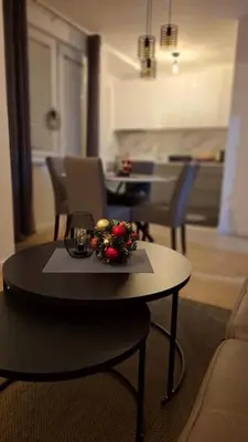 a table in a living room with a table with decorations on it at Apartman MARIA Livno in Livno