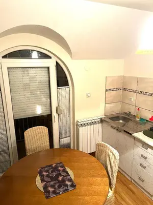 a kitchen with a table and chairs in a room at La Simba in Banja Luka