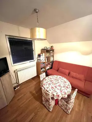 a living room with a red couch and a table at La Simba in Banja Luka