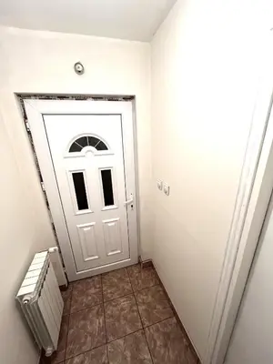 a white door in a room with a tile floor at La Simba in Banja Luka
