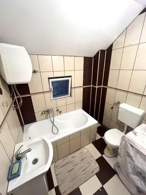 a bathroom with a sink and a tub and a toilet at La Simba in Banja Luka