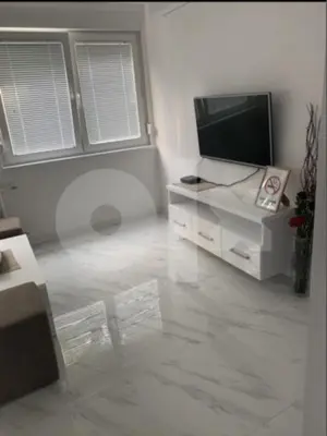 a living room with a flat screen tv on a white cabinet at Apartman 078 in Banja Luka